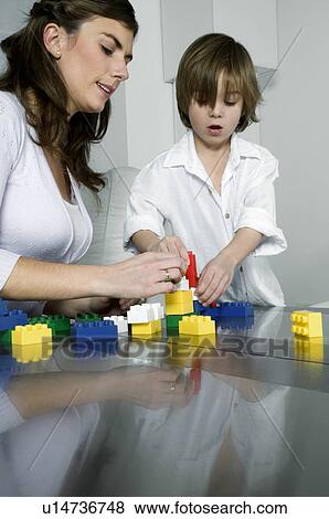Young woman and boy playing with building blocks View Large Photo Image Stock Photo - Young woman and boy playing with building blocks. Fotosearch
