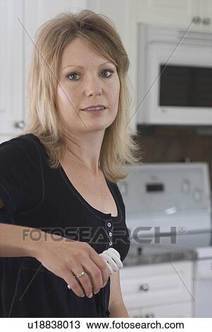40 ish woman holding compact flourescent light bulb, Brandon, Canada View Large Photo Image Stock Image - 40 ish woman holding compact flourescent light bulb, Brandon, Canada. Fotosearch