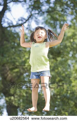 6 year old girl jumping, Winnipeg, Canada View Large Photo Image Picture - 6 year old girl jumping, Winnipeg, Canada. Fotosearch