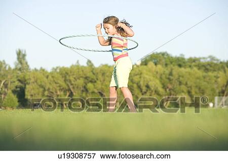 6 year old girl playing with hula hoop, Winnipeg, Canada View Large Photo Image Stock Photo - 6 year old girl playing with hula hoop, Winnipeg, Canada. Fotosearch