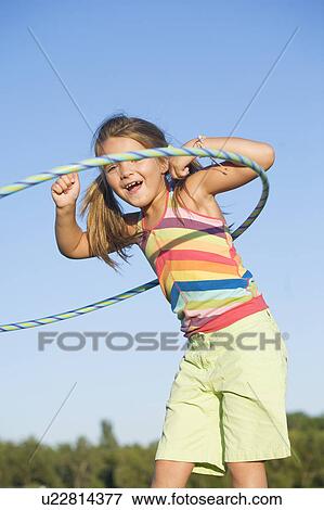 6 year old girl playing with hula hoop, Winnipeg, Canada View Large Photo Image Stock Photo - 6 year old girl playing with hula hoop, Winnipeg, Canada. Fotosearch