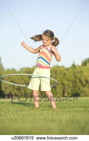 6 year old girl playing with hula hoop, Winnipeg, Canada View Large Photo Image Stock Photo - 6 year old girl playing with hula hoop, Winnipeg, Canada. Fotosearch