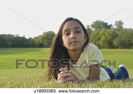 8 year old girl lying on grass in park, Winnipeg, Canada View Large Photo Image Stock Photography - 8 year old girl lying on grass in park, Winnipeg, Canada. Fotosearch