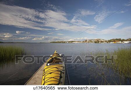 Stock Photography - A beautiful summer day on a dock overlooking the Back Bay portion of the Great Slave Lake in Yellowknife, Northwest Territories.. Fotosearch