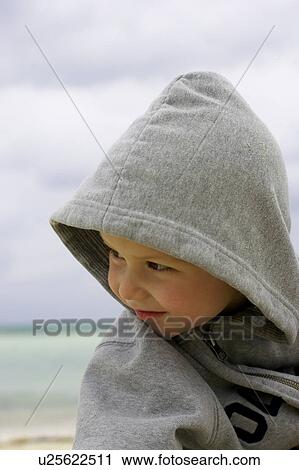 Stock Image - Boy in hoodie on the beach, CamagÃƒÂ¼ey, Cuba. Fotosearch