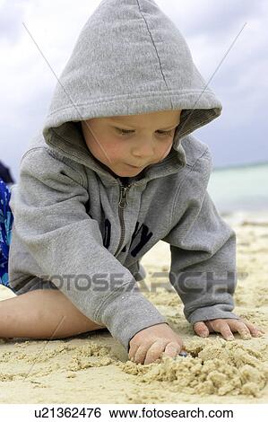 Boy playing in sand on the beach, Camagüey, Cuba View Large Photo Image Stock Photograph - Boy playing in sand on the beach, Camagüey, Cuba. Fotosearch