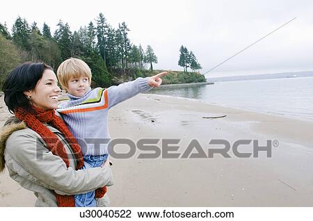 Boy with mother points out across water, Vancouver, British Columbia View Large Photo Image Stock Image - Boy with mother points out across water, Vancouver, British Columbia. Fotosearch