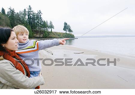 Boy with mother points out across water, Vancouver, British Columbia View Large Photo Image Stock Photo - Boy with mother points out across water, Vancouver, British Columbia. Fotosearch