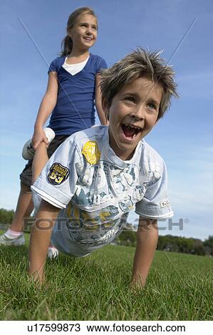 Eight year old bos and girl playing wheelbarrow, Winnipeg, Canada View Large Photo Image Stock Image - Eight year old bos and girl playing wheelbarrow, Winnipeg, Canada. Fotosearch