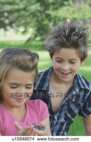 Eight year old boy and six year old girl with turtle, Winnipeg, Canada View Large Photo Image Picture - Eight year old boy and six year old girl with turtle, Winnipeg, Canada. Fotosearch