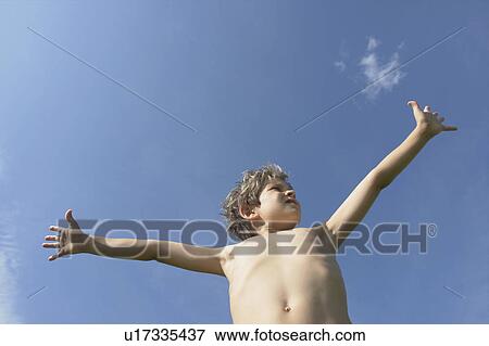 Eight year old boy with arms outstretched, Winnipeg, Canada View Large Photo Image Stock Photo - Eight year old boy with arms outstretched, Winnipeg, Canada. Fotosearch