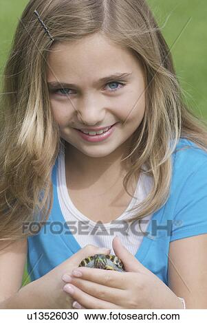 Eight year old girl holding turtle, Winnipeg, Canada View Large Photo Image Stock Image - Eight year old girl holding turtle, Winnipeg, Canada. Fotosearch