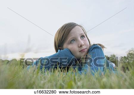Eight year old girl lying in grass looking upward, Winnipeg, Canada View Large Photo Image Stock Image - Eight year old girl lying in grass looking upward, Winnipeg, Canada. Fotosearch