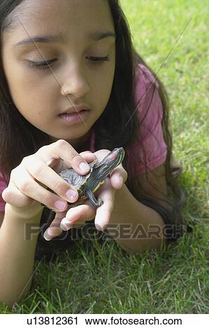 Eight year old girl lying in grass with turtle, Winnipeg, Canada View Large Photo Image Stock Image - Eight year old girl lying in grass with turtle, Winnipeg, Canada. Fotosearch