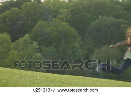 Stock Photo - Eight year old girl running, blurred, Winnipeg, Canada. Fotosearch