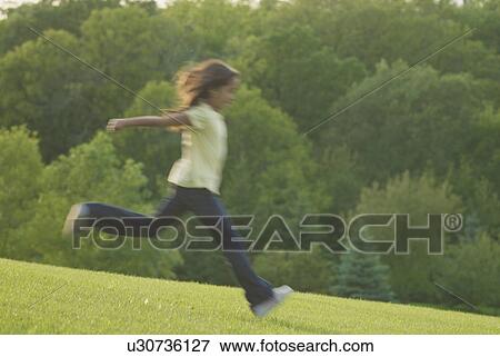 Eight year old girl running, blurred, Winnipeg, Canada View Large Photo Image Stock Photo - Eight year old girl running, blurred, Winnipeg, Canada. Fotosearch