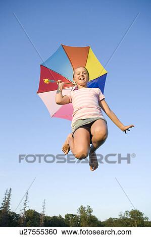 Eleven year old girl jumping high with umbrella, Winnipeg, Canada View Large Photo Image Stock Image - Eleven year old girl jumping high with umbrella, Winnipeg, Canada. Fotosearch
