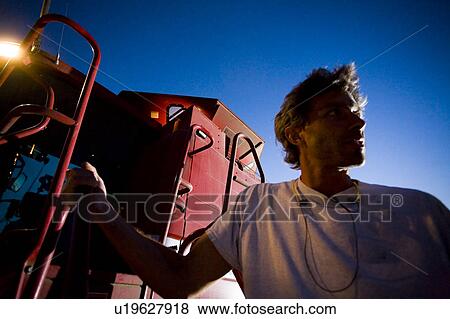 Farmer beside combine, Saskatchewan View Large Photo Image Stock Photo - Farmer beside combine, Saskatchewan. Fotosearch