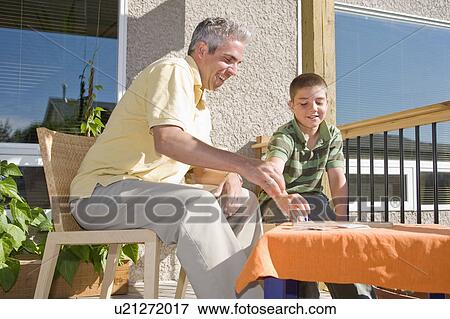 Father and son playing cribbage on deck, Winnipeg, Canada View Large Photo Image Stock Photo - Father and son playing cribbage on deck, Winnipeg, Canada. Fotosearch