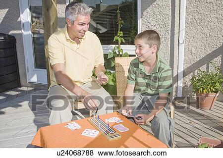 Father and son playing cribbage on deck, Winnipeg, Canada View Large Photo Image Stock Photo - Father and son playing cribbage on deck, Winnipeg, Canada. Fotosearch