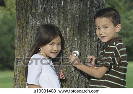 Five year old sister and seven year old brother with stethescope on tree, Winnipeg, Canada View Large Photo Image Stock Photo - Five year old sister and seven year old brother with stethescope on tree, Winnipeg, Canada. Fotosearch
