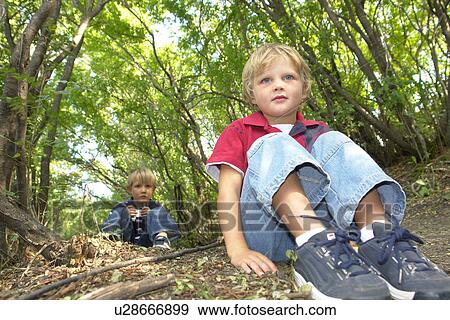 Four and six year old brothers on seated on walking trail in forest, Winnipeg, Canada View Large Photo Image Stock Photo - Four and six year old brothers on seated on walking trail in forest, Winnipeg, Canada. Fotosearch