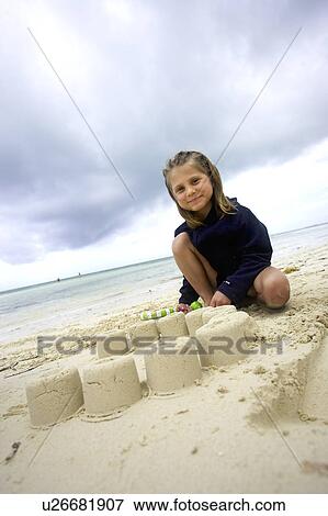 Girl making a sand castle on the beach, Camagüey, Cuba View Large Photo Image Stock Photo - Girl making a sand castle on the beach, Camagüey, Cuba. Fotosearch