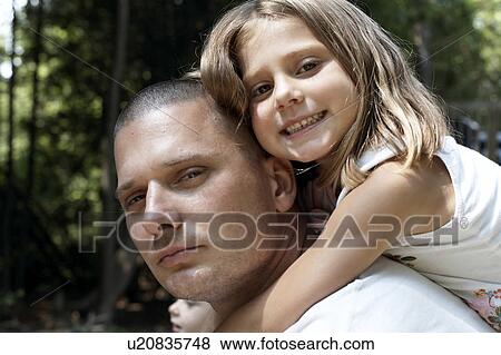 Stock Photo - Girl on father's shoulders, CamagÃƒÂ¼ey, Cuba. Fotosearch