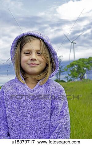 Stock Photo - Girl standing in front of wind turbine, Tiverton, Bruce Peninsula, Ontario. Fotosearch