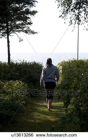 Girl walking down garden path to the lake, Victoria Beach, Manitoba View Large Photo Image Stock Photograph - Girl walking down garden path to the lake, Victoria Beach, Manitoba. Fotosearch