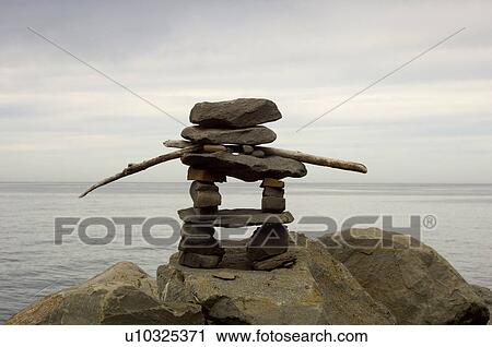 Stock Image - Inukshuk by river, Gaspesie, Quebec. Fotosearch