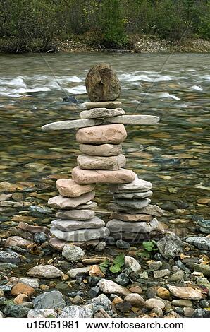 Stock Image - Inukshuk by river, Gaspesie, Quebec. Fotosearch