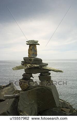Stock Image - Inukshuk, by river, Gaspesie, Quebec. Fotosearch
