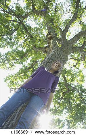 Low angle, 13 year old girl beside tree, Winnipeg, Canada View Large Photo Image Stock Photo - Low angle, 13 year old girl beside tree, Winnipeg, Canada. Fotosearch