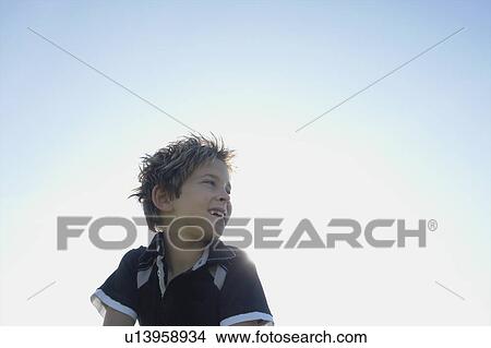 Low angle eight year old boy smiling, Winnipeg, Canada View Large Photo Image Picture - Low angle eight year old boy smiling, Winnipeg, Canada. Fotosearch