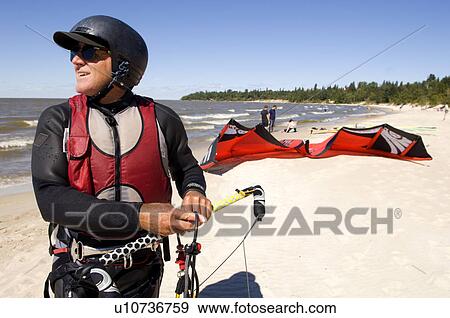 Stock Photo - Man kite boarding, Victoria Beach, Manitoba. Fotosearch