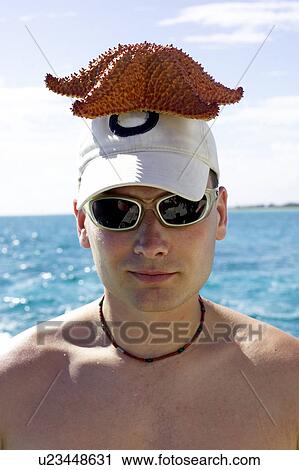Stock Image - Man with starfish on his head, CamagÃƒÂ¼ey, Cuba. Fotosearch