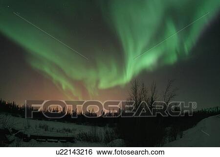 Photographed on the road to Dettah outside of Yellowknife, Northwest Territories; this can be considered an explosion of aurora borealis. The reddish hue is ambient light coming from the city of Yellowknife. View Large Photo Image Stock Photograph - Photographed on the road to Dettah outside of Yellowknife, Northwest Territories; this can be considered an explosion of aurora borealis. The reddish hue is ambient light coming from the city of Yellowknife. . Fotosearch
