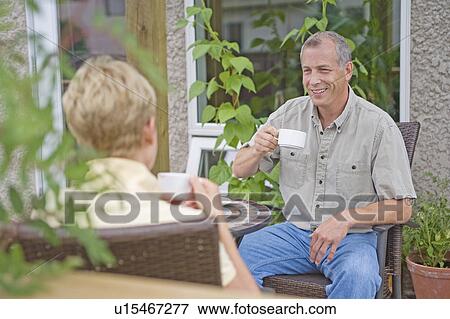 Senior couple enjoying coffee on deck, Winnipeg, Canada View Large Photo Image Stock Photo - Senior couple enjoying coffee on deck, Winnipeg, Canada. Fotosearch