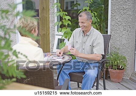Senior couple playing cards on deck, Winnipeg, Canada View Large Photo Image Stock Photography - Senior couple playing cards on deck, Winnipeg, Canada. Fotosearch