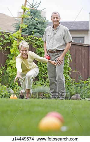Senior couple plays bocce ball in backyard, Winnipeg, Canada View Large Photo Image Picture - Senior couple plays bocce ball in backyard, Winnipeg, Canada. Fotosearch
