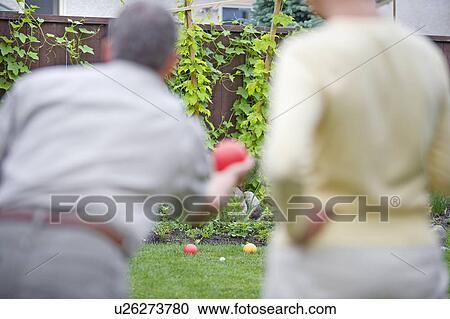 Senior couple plays bocce ball in backyard, Winnipeg, Canada View Large Photo Image Stock Image - Senior couple plays bocce ball in backyard, Winnipeg, Canada. Fotosearch