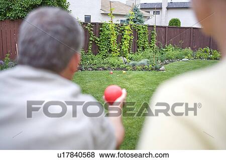 Senior couple plays bocce ball in backyard, Winnipeg, Canada View Large Photo Image Stock Photo - Senior couple plays bocce ball in backyard, Winnipeg, Canada. Fotosearch