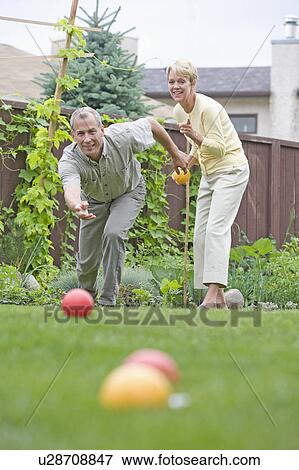Senior couple plays bocce ball in backyard, Winnipeg, Canada View Large Photo Image Stock Photo - Senior couple plays bocce ball in backyard, Winnipeg, Canada. Fotosearch