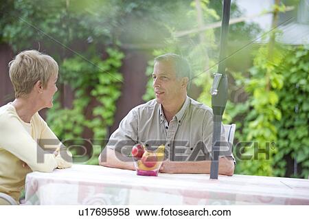 Senior couple seated at outdoor table, Winnipeg, Canada View Large Photo Image Stock Photo - Senior couple seated at outdoor table, Winnipeg, Canada. Fotosearch