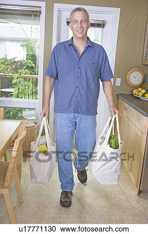 Senior man carrying groceries in cloth bags, Winnipeg, Canada View Large Photo Image Stock Image - Senior man carrying groceries in cloth bags, Winnipeg, Canada. Fotosearch