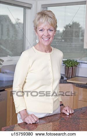 Stock Image - Senior woman in kitchen, Winnipeg, Canada. Fotosearch