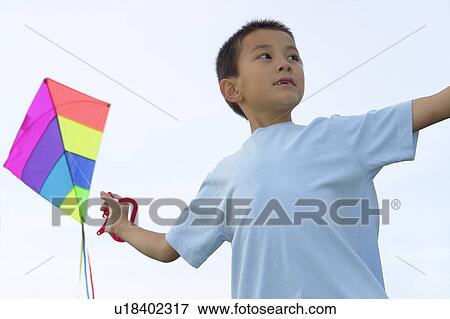 Stock Photo - Seven year old boy with kite, Winnipeg, Canada. Fotosearch