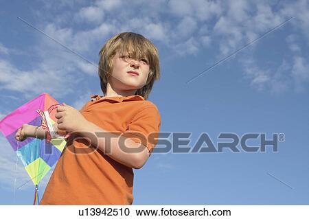 Stock Image - Six year old boy holding kite, Winnipeg, Canada. Fotosearch