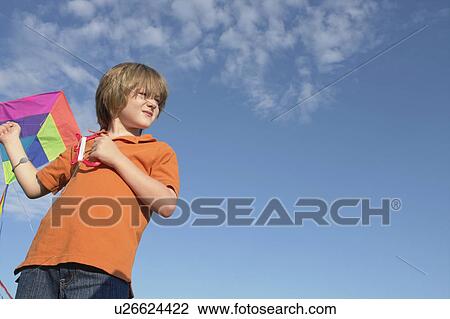 Stock Image - Six year old boy holding kite, Winnipeg, Canada. Fotosearch